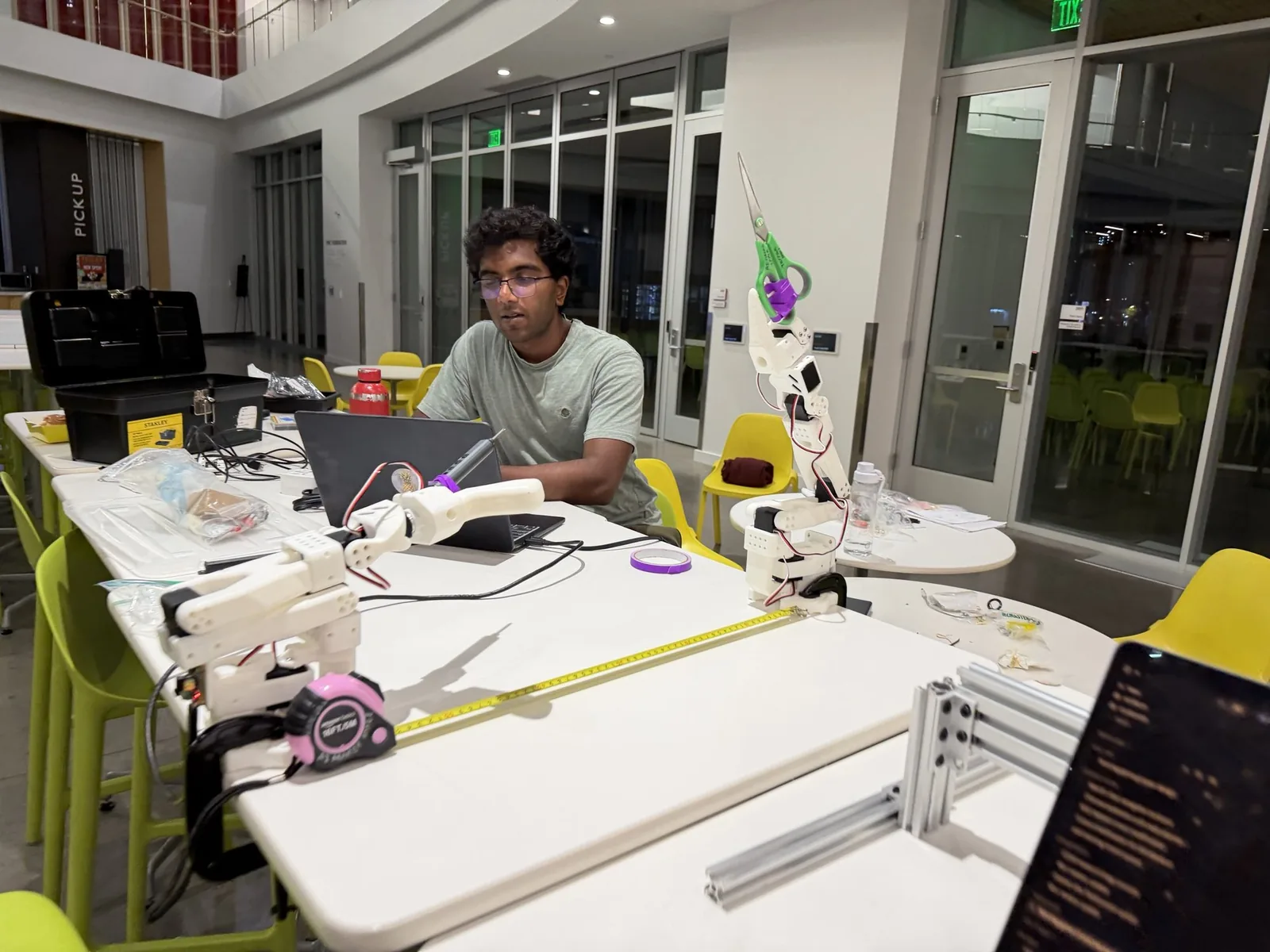 Both arms set out on the tables with a tape measure run between them