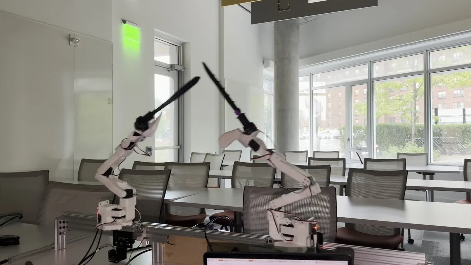 Two real robot arms: a low slash from the left stopped by the right-hand guard